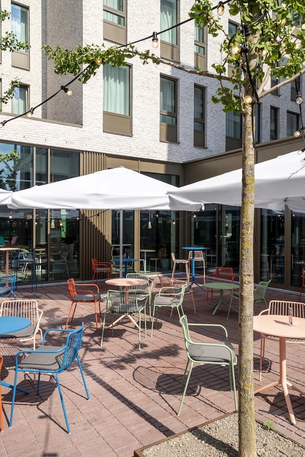 Outdoor terrace with colorful chairs and string lights